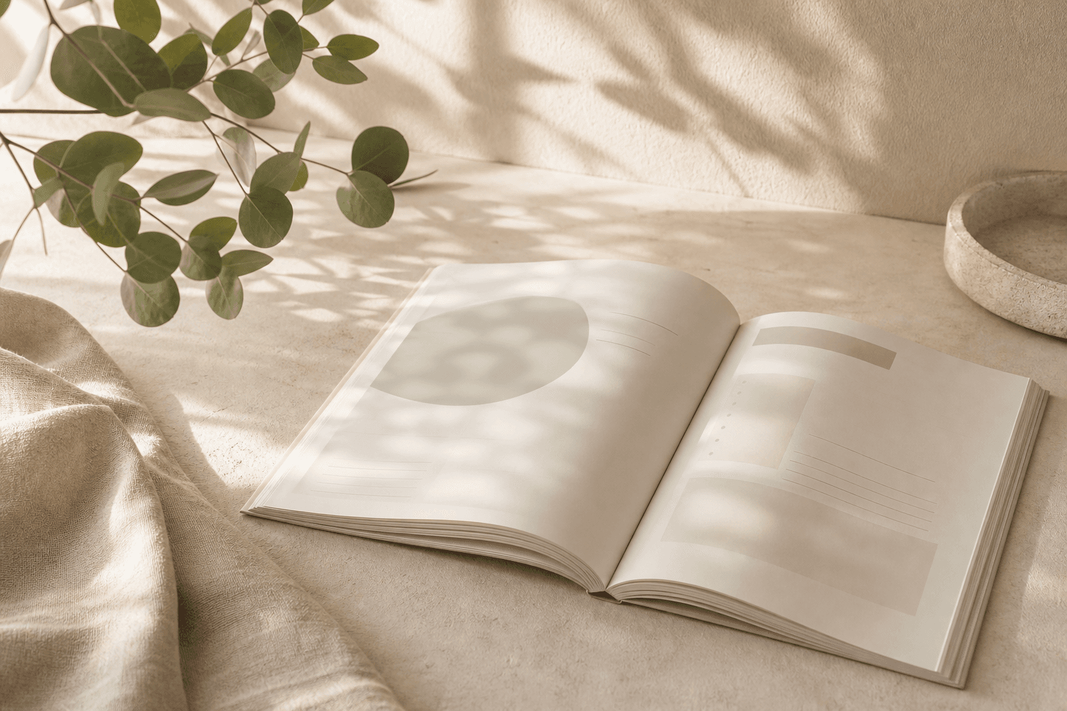 Open workbook on a warm neutral desk with soft greenery and morning light